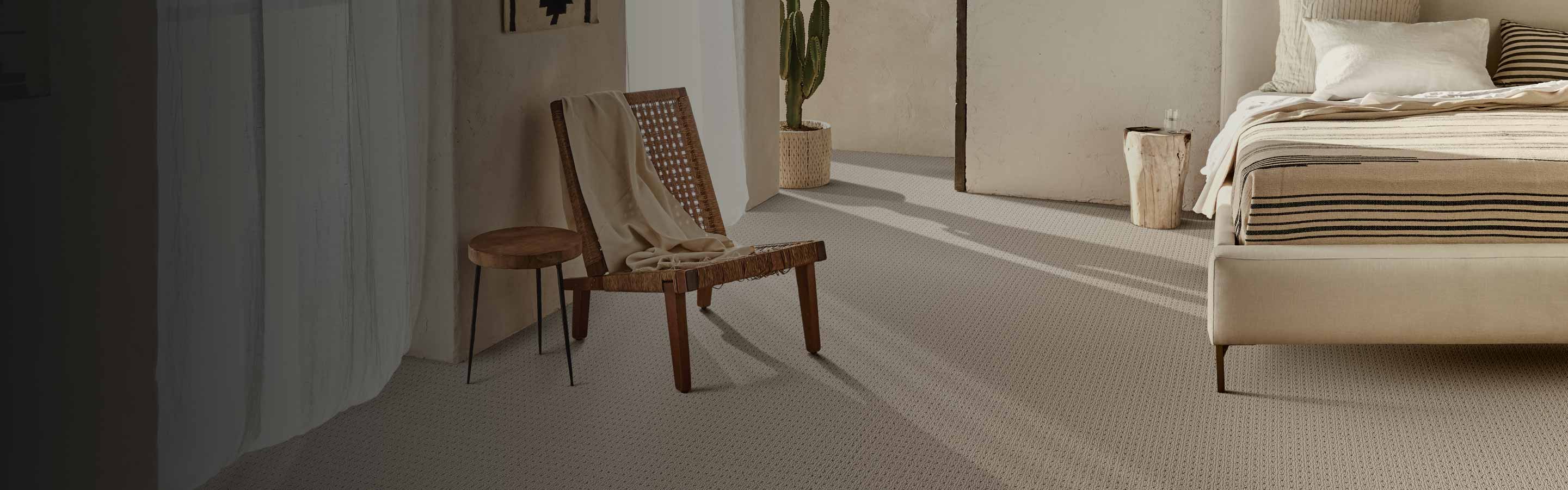 beige neutral toned carpet in contemporary bedroom with limewashed walls and wood accents